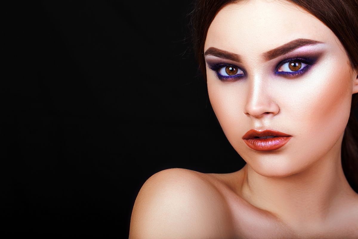 beautiful young girl on a black background with creative makeup, model, makeup, closeup